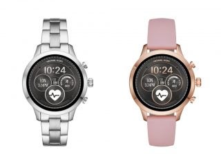 Two different Michael Kors Access Runway smartwatchs standing on white background