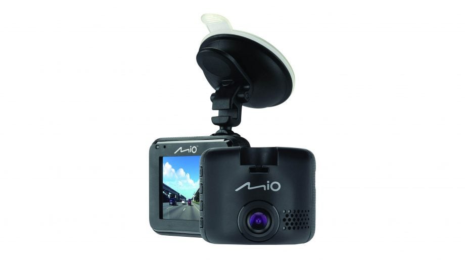 A black Mio MiVue C330's camera and mini screen kept on a white background