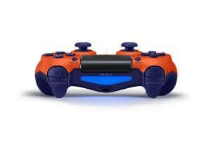 Top side panel view of an orange-blue PS4 Dualshock gaming controller kept on a white background