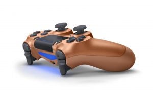 Top back right angled view of a brown PS4 Dualshock gaming controller kept on a white background