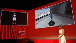 Vodafone UK's Anne Sheehan wearing a Microsoft HoloLens and talking with a hologram of Steph Houghton