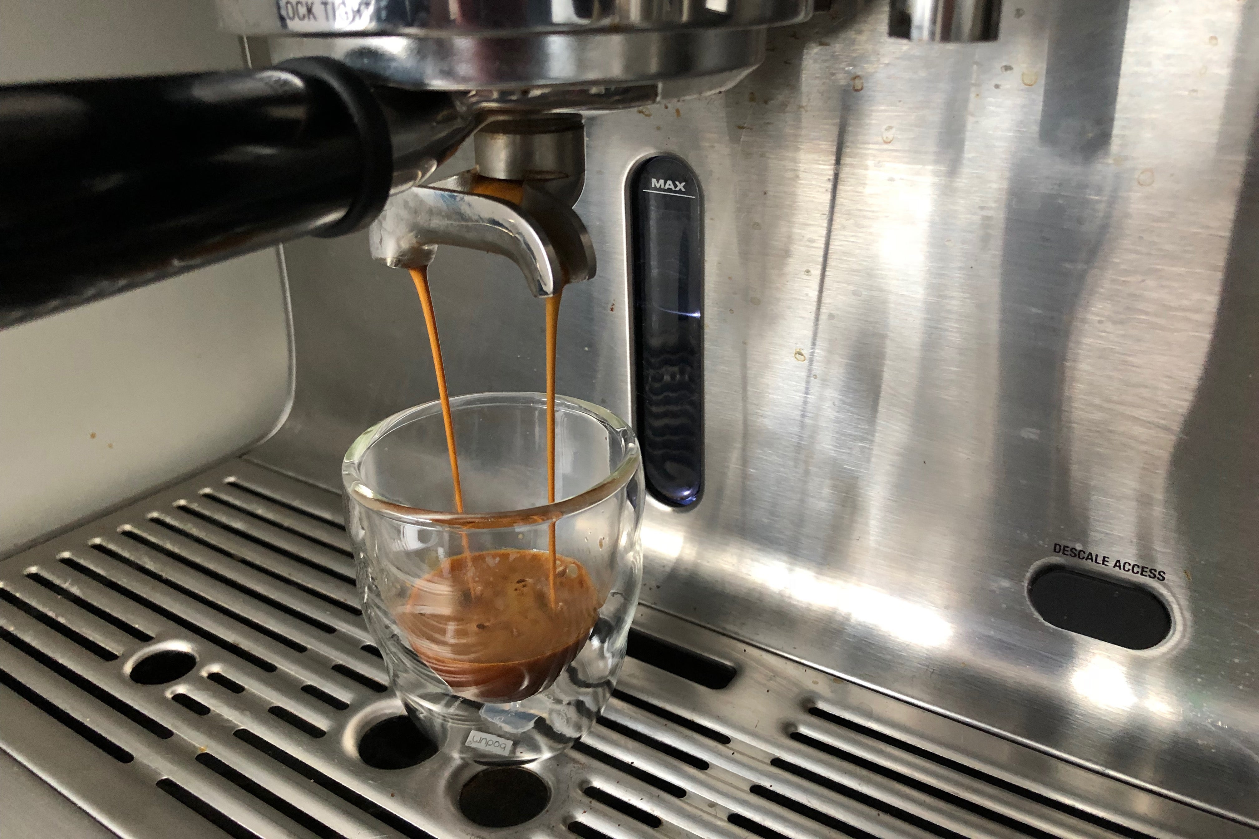 Adjust a coffee grinder pull a shot