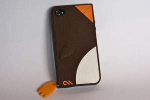 View from top of a brown Case Mate Waddler Penguin case for iPhone 5S kept on a silver background