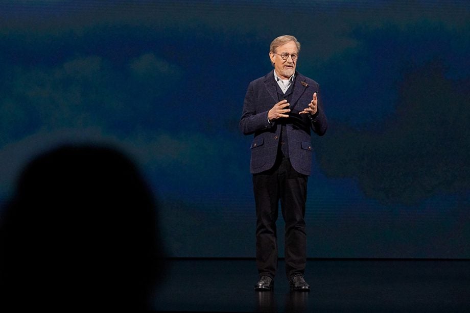 An old man wearing glasses standing on stage, picture from Apple keynotes event