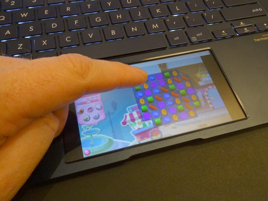 Close up view of Candy Crush being played on touchpad of a Asus Zenbook 2019