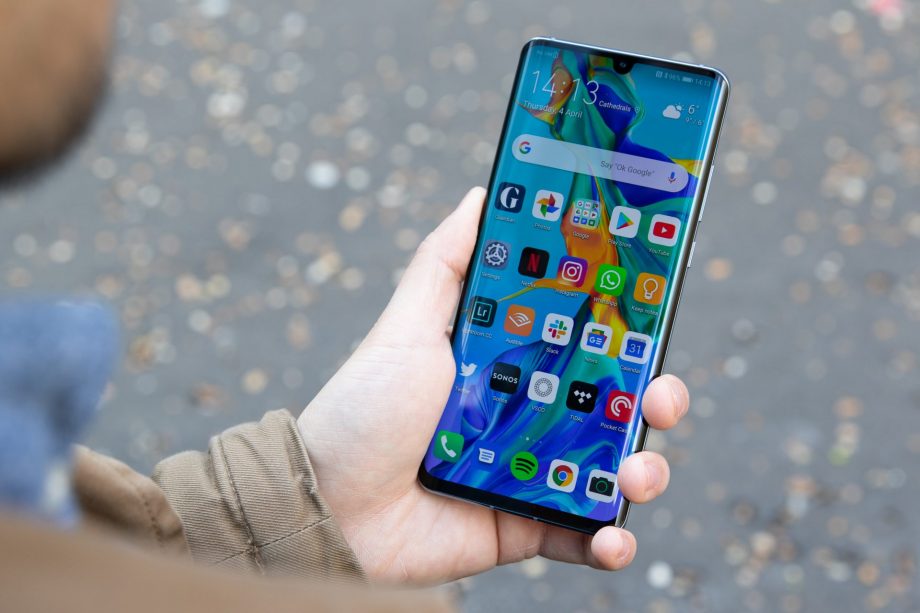 A Huawei P30 Pro held in hand displaying homescreen