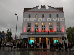 A building named The OLD VIC, all my sons with people standing in front of it