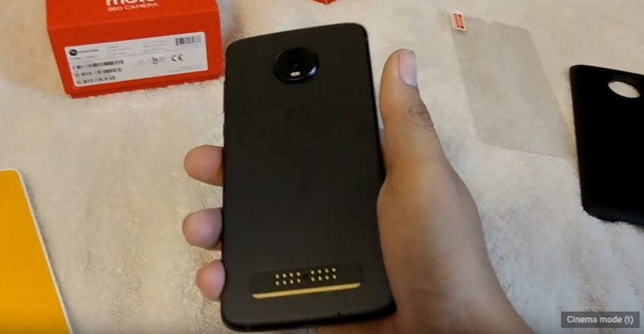 Back panel view of a black Motorola Z4 smartphone held in hand facing down