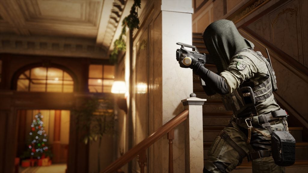 A screenshot of a scene about a masked person holding a gun from a game called Tom Clancy's Rainbow Six Siege