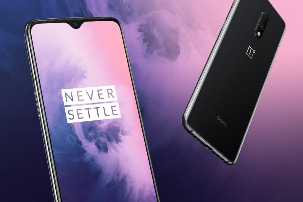 A wallpaper of black OnePlus 7 smartphones showing front and back panel