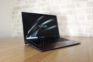 Left angled view of a brown Vaio SX14 laptop kept on a table diplaying homescreen