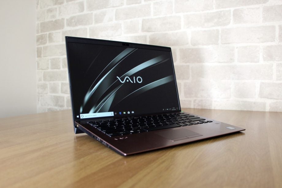 Left angled view of a brown Vaio SX14 laptop kept on a table diplaying homescreen