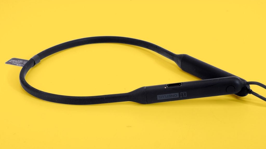 OnePlus Bullets Wireless 2Close up view of OnePlus Bullets wireless 2 earphones's collar band kept on a yellow background