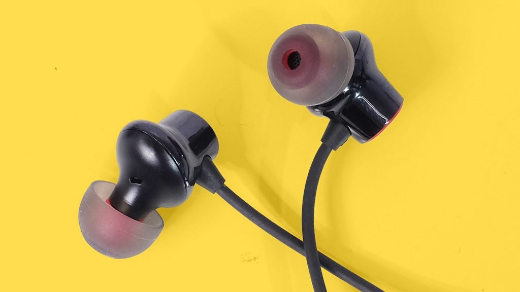 OnePlus Bullets Wireless 2Close up view of OnePlus Bullets wireless 2 earphones's earbuds kept on a yellow background