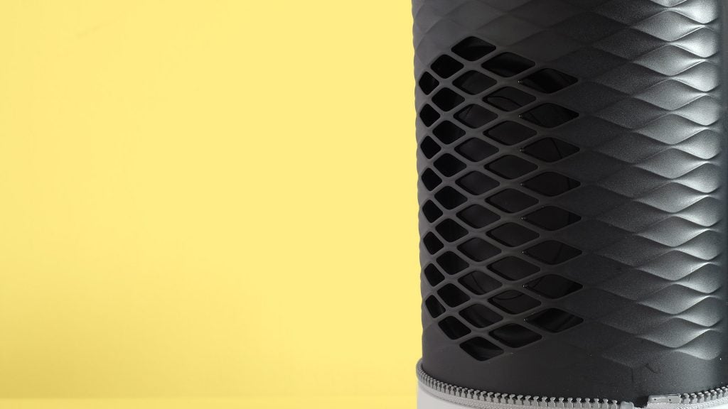 Zipp 2Side view of middle part of a black-white Libratone speaker standing on yellow background