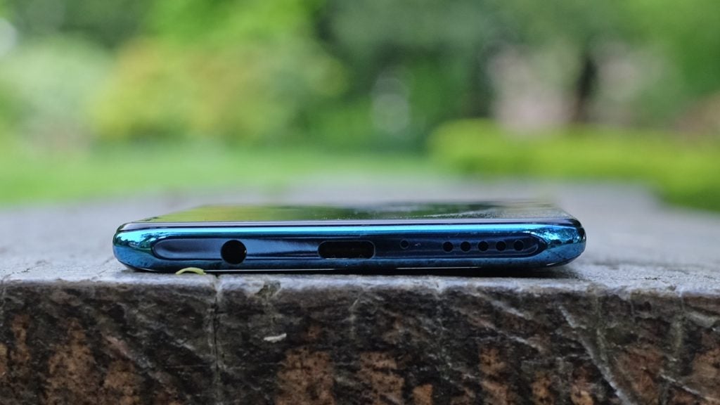 Bottom edge view of a Huawei P30 Lite kept on a wooden surface