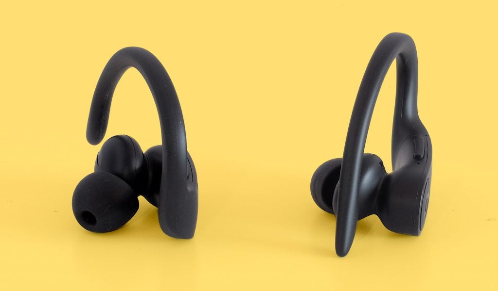 Powerbeats ProClose up view of a black Powerbeats earbuds standing on a yellow background
