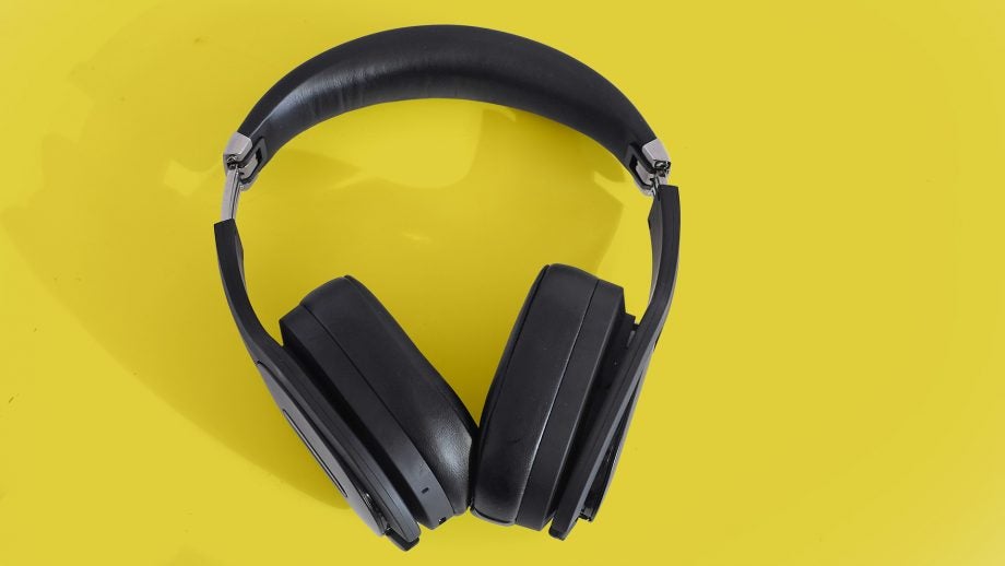 View from top of black PSB headphones kept on a yellow background