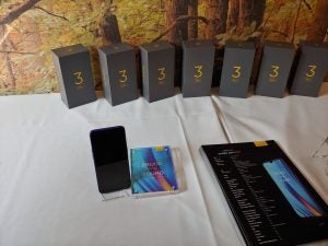 A table with Realme 3 Pro smartphone and it's boxes standing on it, picture from Realme 3 Pro's launch event