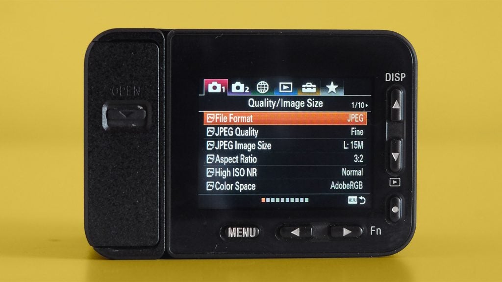 Screen panel view of a black Sony RX0 II kept on a yellow background