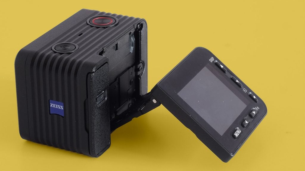 Left angled view of a black Sony RX0 II kept on a yellow background with it's screen stretched outLeft angled back panel view of a black Sony RX0 II kept on a yellow background