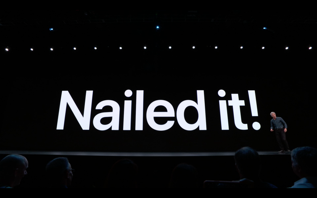 A man standing on stage with nailed it displayed on the screen behind