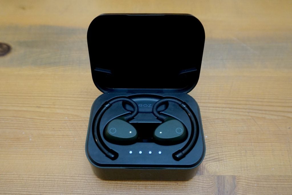 EOZ AirBlack EOZ Air earbuds resting in it's case kept on a wooden table