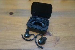 Black EOZ Air earbuds with it's case behind kept on a wooden table
