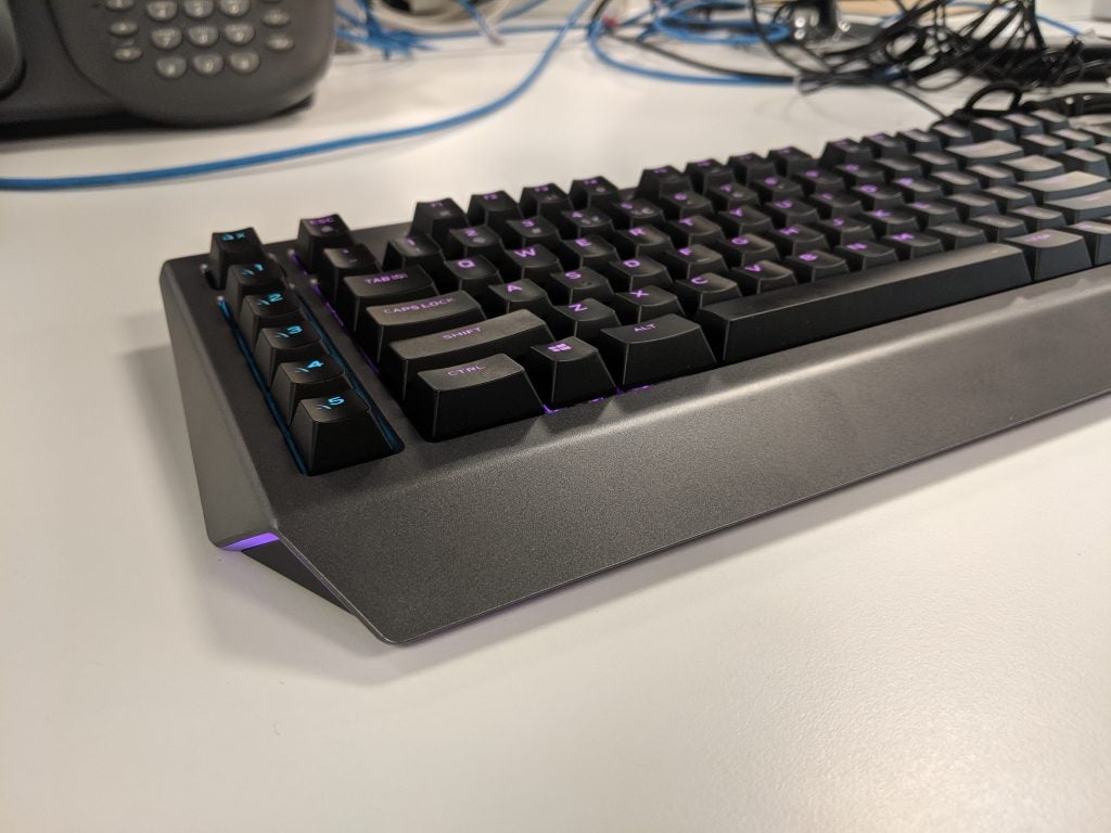 Left angled half part view of a gray-black Alienware keyboard kept on a white table