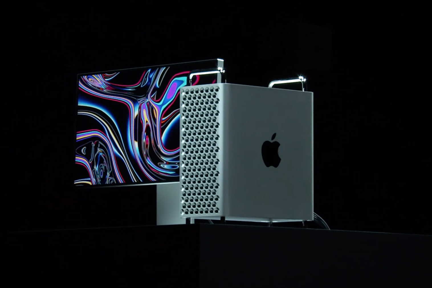 Apple Mac Pro 2019A man standing on a stage with Radeon Pro Vega II displayed on the screen behind