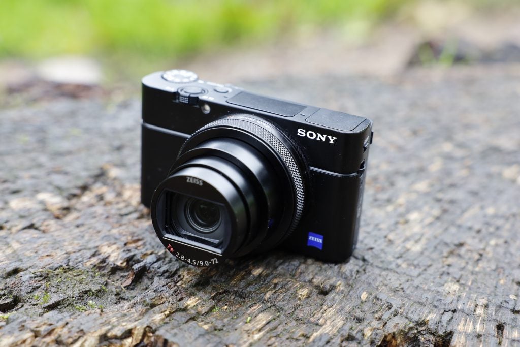 Front right view of a black Sony RX100 VII camera standing on ground