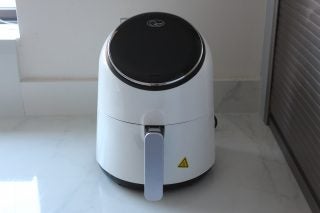 A white-black Quest Digital LCD Air Fryer kept on a white table