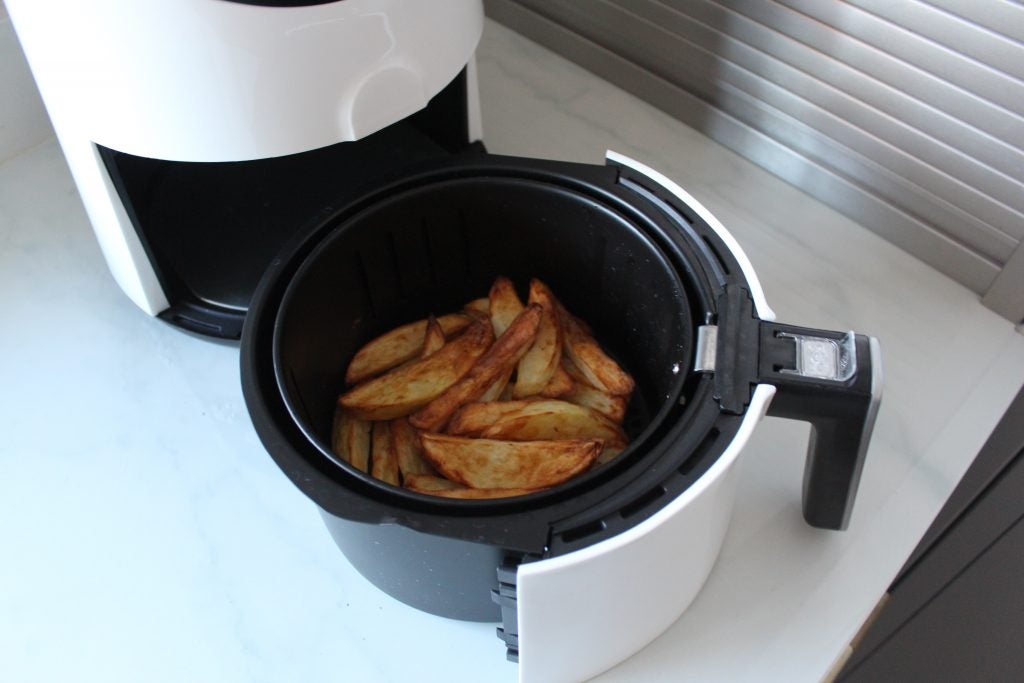 Close up view of a Quest Digital LCD Air Fryer's container with fried French fries kept inside