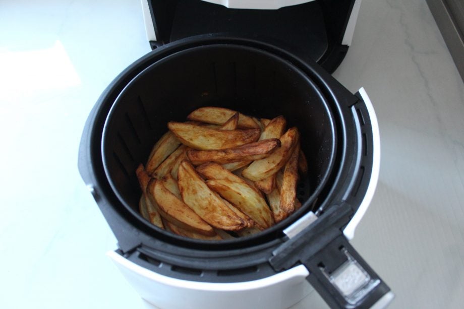 Close up view of a Quest Digital LCD Air Fryer with fried French fries kept inside