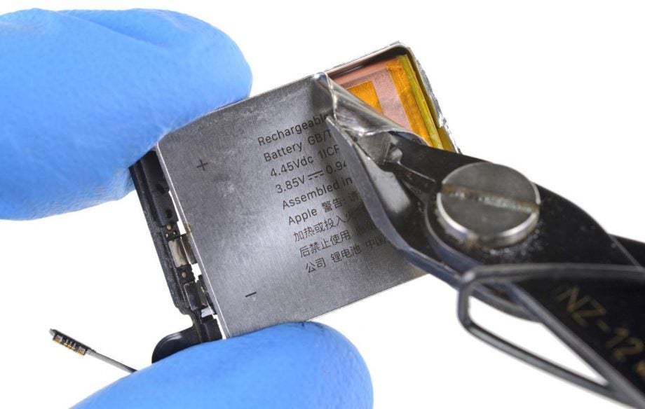 Close up view of an Apple Watch Series 5's battery metal layer being removed