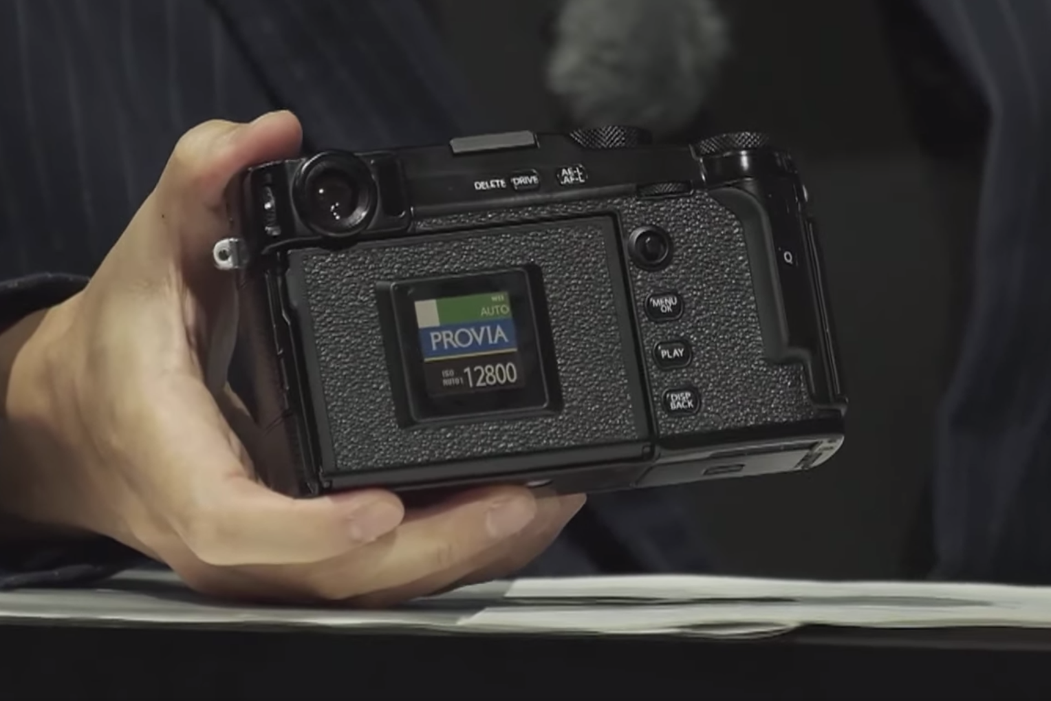 A black Fujifilm X Pro 3 held in hand