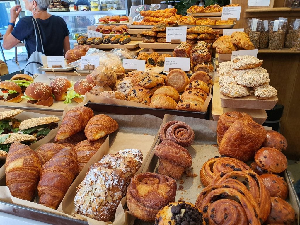 Close up view of food items arranged in a bakery, picture taken from Samsung Galaxy Note 10 Plus, artificial light
