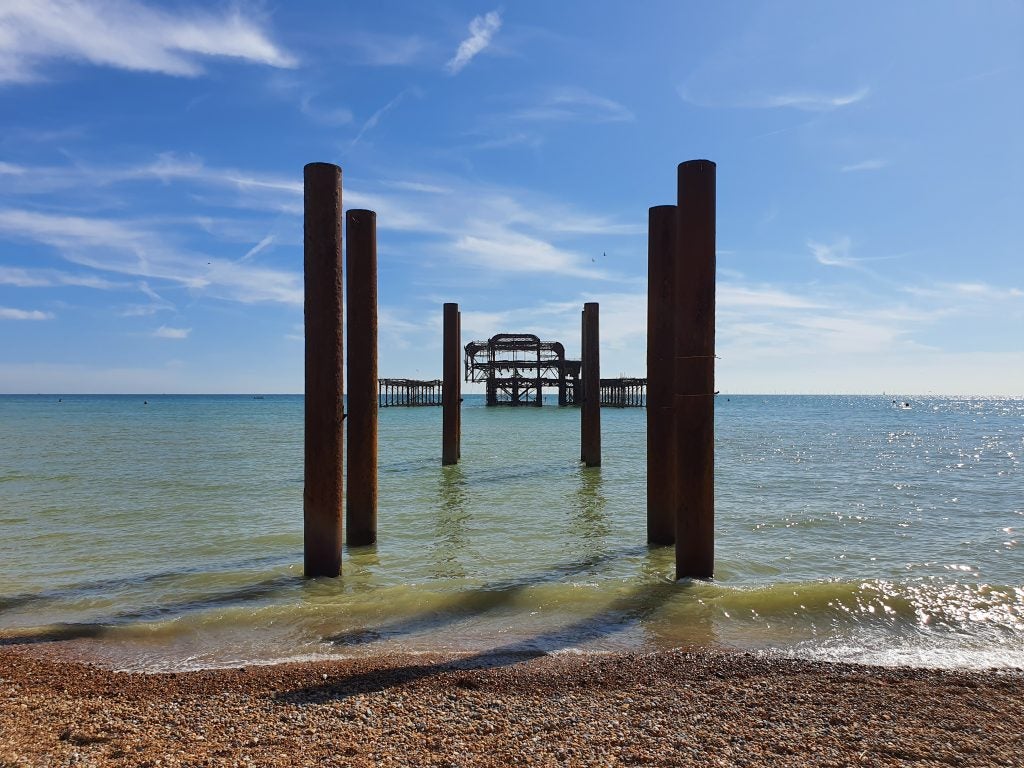 A beach with big pipes standing in water, picture taken from Samsung Galaxy Note 10 Plus, natural light