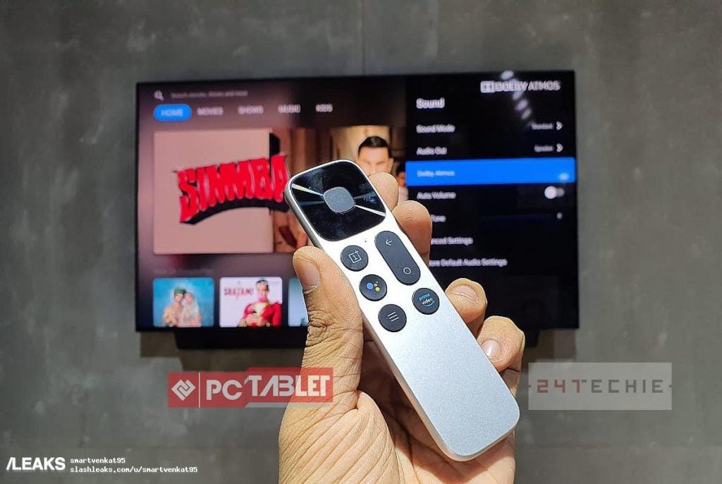A silver One Plus TV's remote held in hand