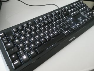 Left angled view of a black Cherry keyboard kept on a white table