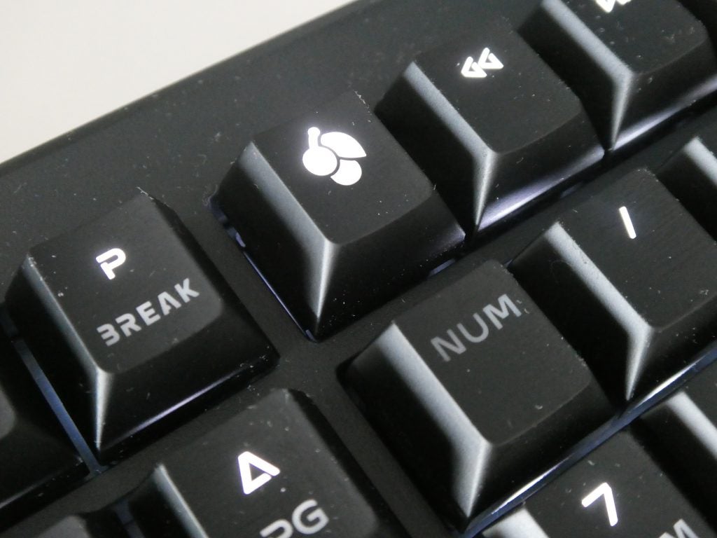 Close up view of a cherry key on a black Cherry keyboard