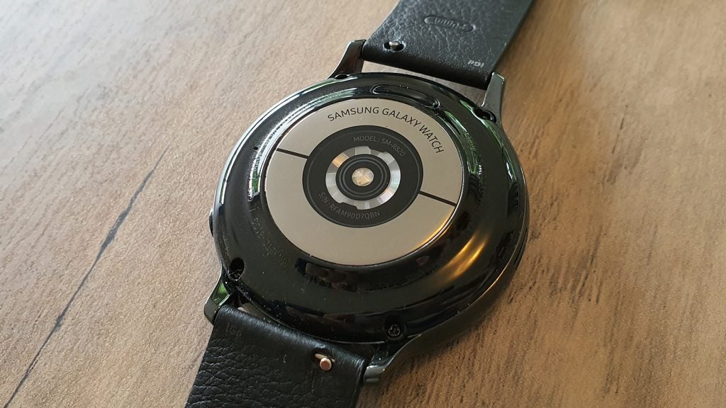 Back panel view of a black Samsung Galaxy Watch Active 2 kept on a table
