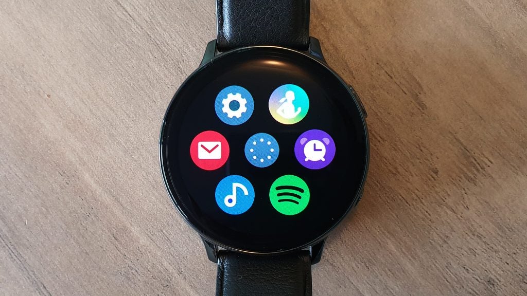 A black Samsung Galaxy Watch Active 2 kept on a table displaying menu screen
