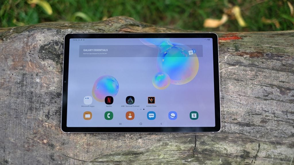 View from top of a Samsung Galaxy Tab S6 kept on a wooden surface displaying homescreen