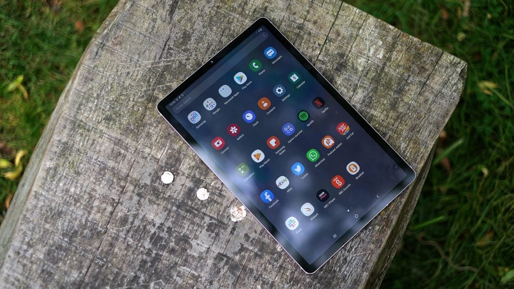 View from top of a Samsung Galaxy Tab S6 kept on a wooden surface displaying menu screen