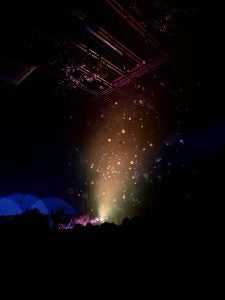 A night event or concert with crowd dancing and light pointing roof, picture taken from iPhone 11 Pro Max