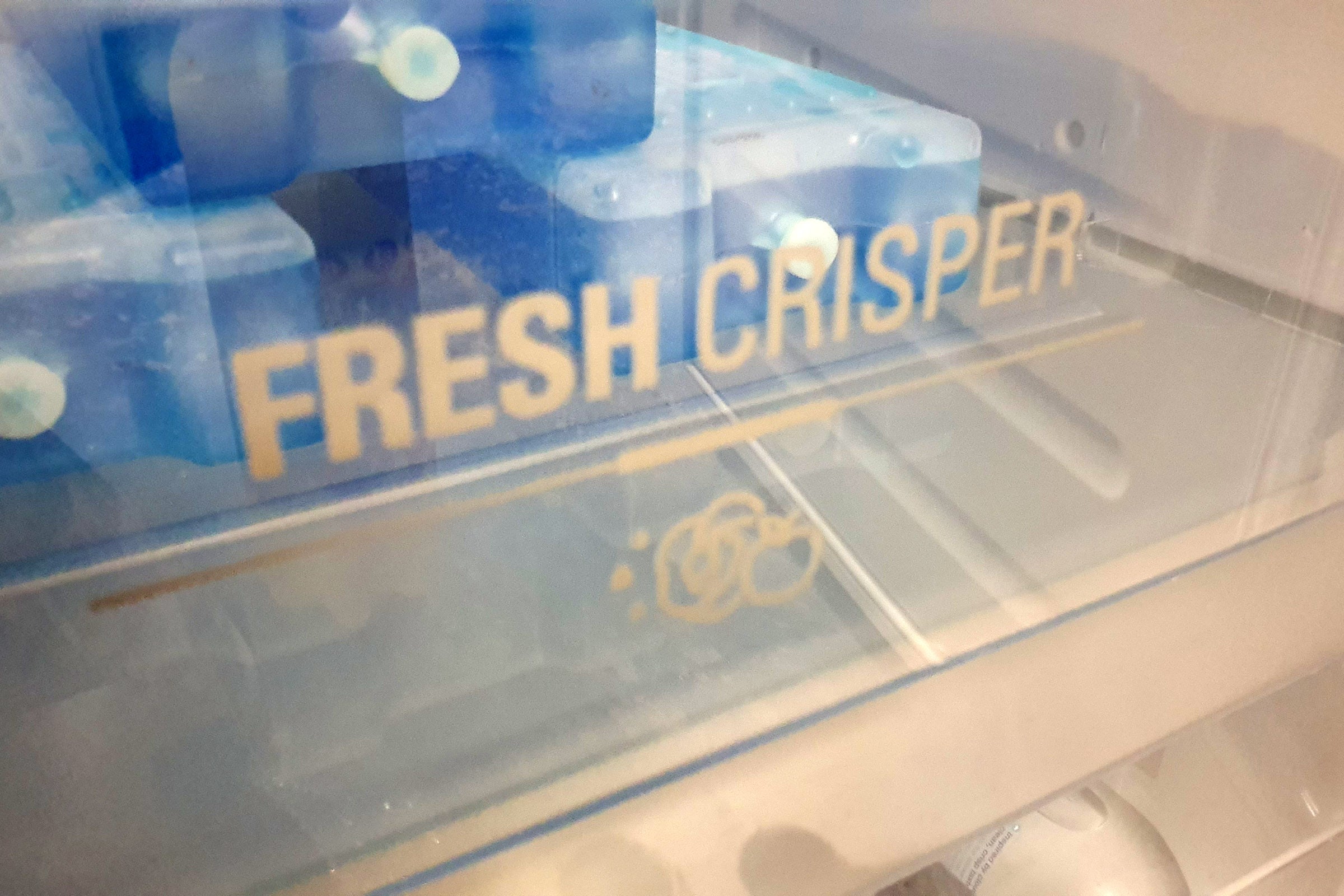 Close up view of a container with fresh crisper printed on it
