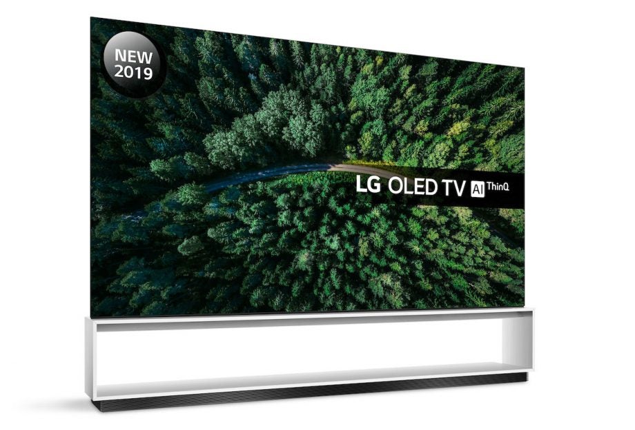 Left angled view of a black LG OLED88Z9 TV standing on a stand on white background