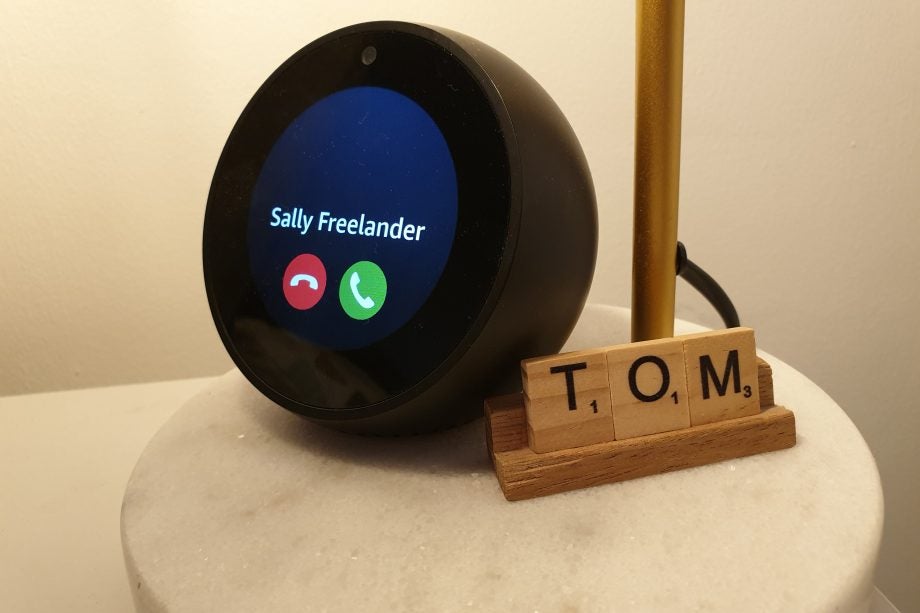 Side view of Amazon Alexa kept on a table displaying an incoming call from Sally Freelancer