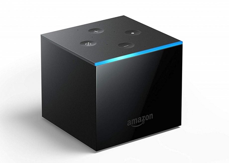 Left angled view of a black Amazon Fire TV Cube standing on white background